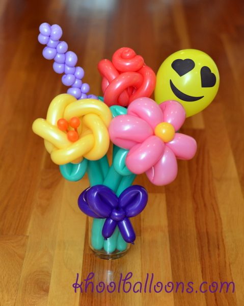 A bouquet of five flower balloons in glass jar